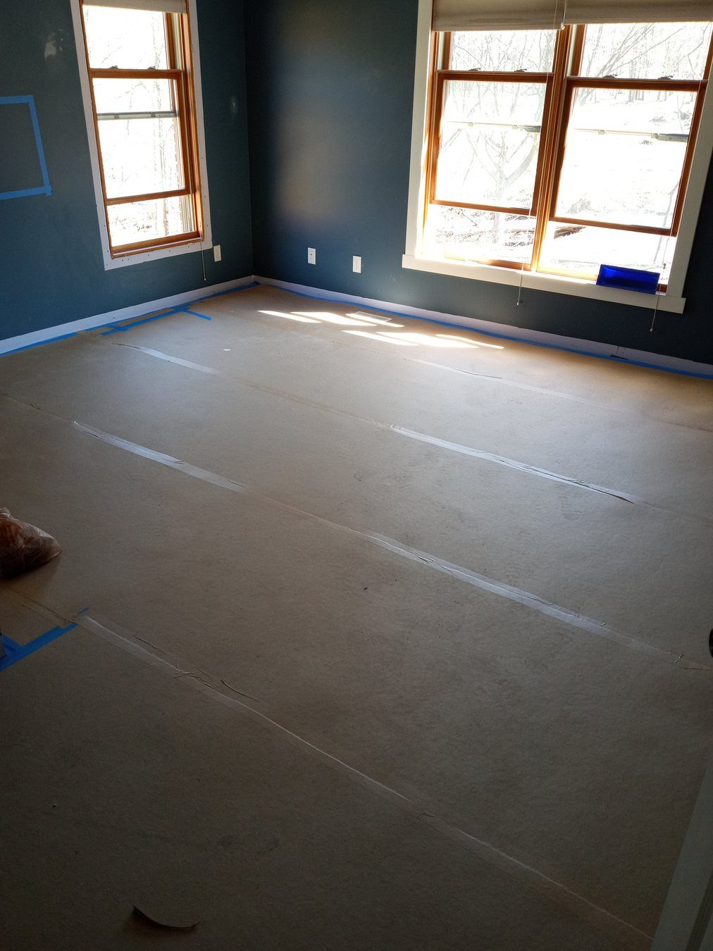 Protected flooring during room preparation work.