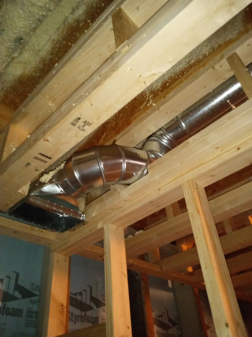 Open wall framing showing plumbing and fixture rough-in work.